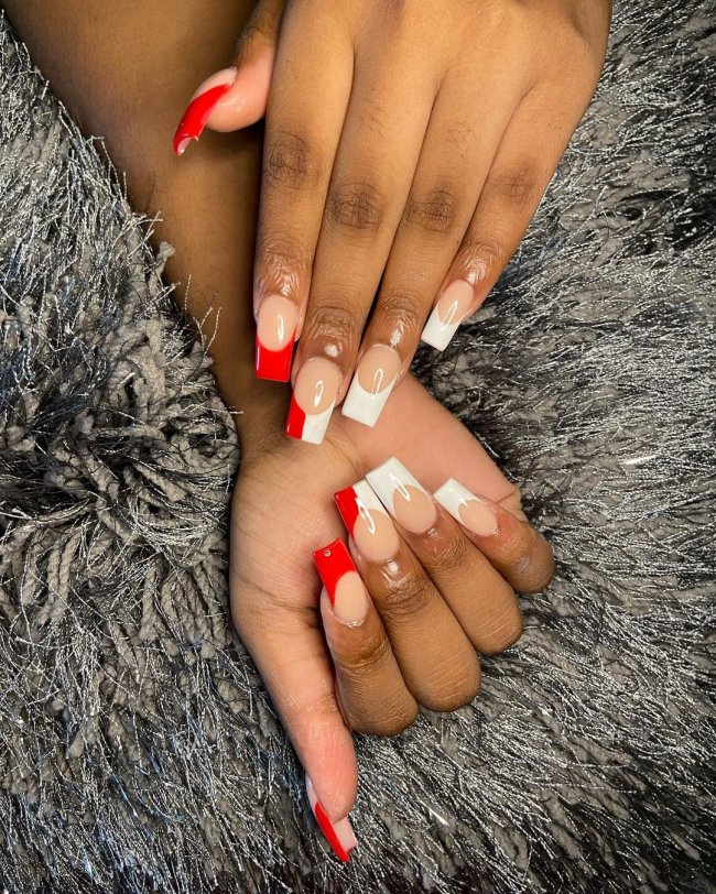 unha com francesinha vermelha Foto com close nas unhas de duas mãos. Ela está com francesinha branca e vermelha nas unhas.