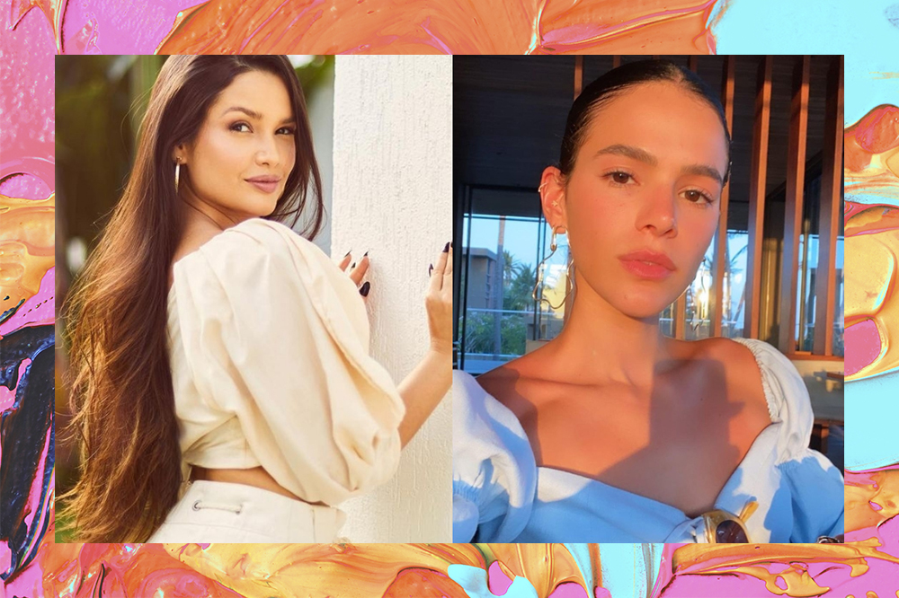 Montagem em fundo com tintas em laranja, azul e rosa de foto da Juliette à esquerda e da Bruna Marquezine à direita. Juliette está de costas, com as mãos na parede, usando cropped amarelo de mangas bufantes e com expressão facial séria. Bruna está com blusa branca, cabelo preso em coque e expressão facial séria.