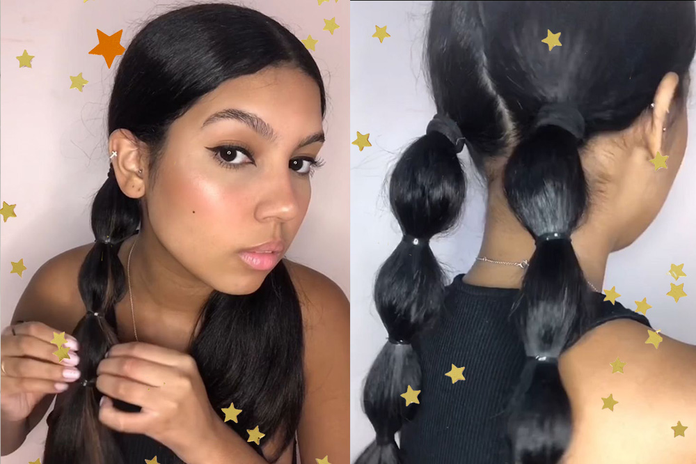 Tutorial-penteados- fáceis-e-incríveeis-para-você-arrasar-no-Lollapalooza Montagem mostra, de uma lado, Adrieny Magalhães usando regata preta e olhando para a câmera em direção ao seu cabelo. No cabelo ela faz uma maria-chiquinha com trança bolha. De outro, ela aparece de costas e mostra o resultado final do penteado. A imagem segue acompanhada de estrelinhas douradas.