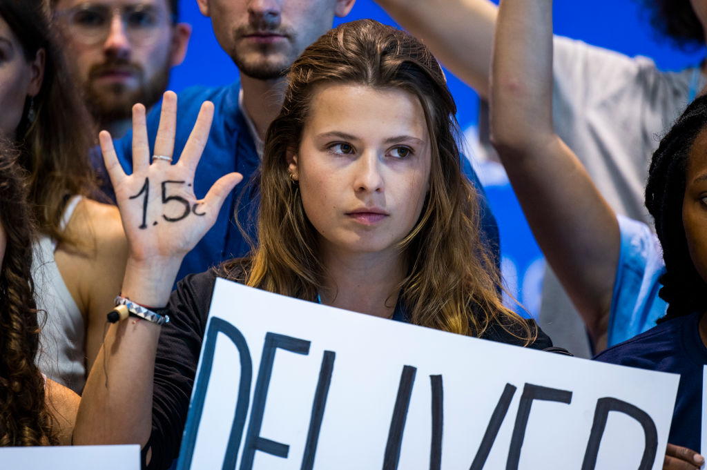 19 November 2022, Egypt, Scharm El Scheich: Luisa Neubauer, a climate activist with the Fridays for Future movement, stands at a demonstration at the U.N. Climate Summit COP27, showing her palm labeled with the 1.5-degree target. Photo: Christophe Gateau/dpa (Photo by Christophe Gateau/picture alliance via Getty Images)