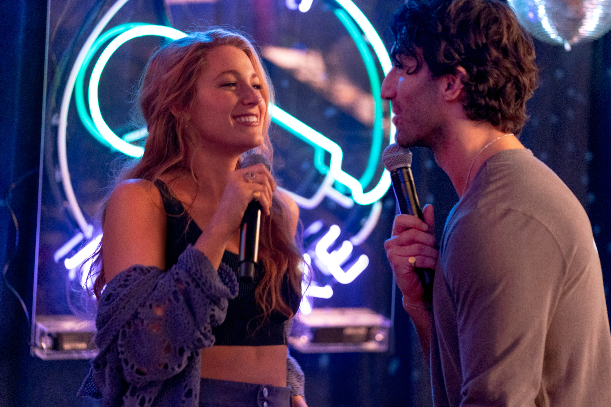 Blake Lively e Justin Baldoni cantando juntos em cena de É Assim Que Acaba; eles estão se olhando e sorrindo um para o outro