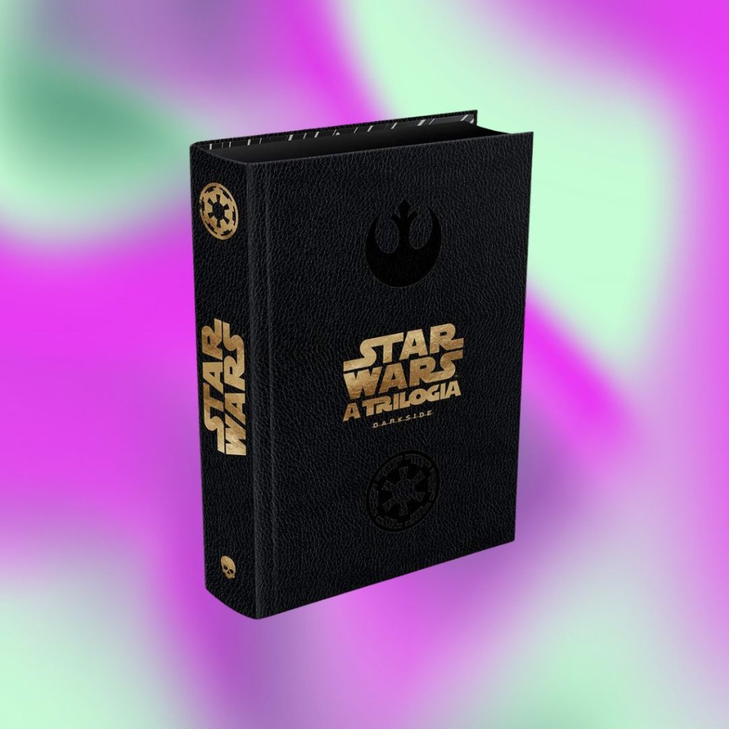 livro Livro Star Wars A Trilogia preto com detalhes dourados em fundo degradê em roxo e verde